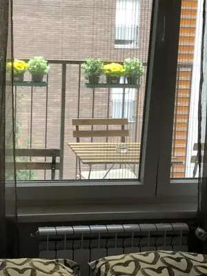 a room with a window with a table and a bench at Yellow Gate in Novi Grad