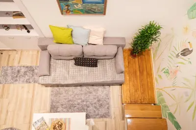 a living room with a couch with pillows on it at KARIOKA apartman in Belgrade