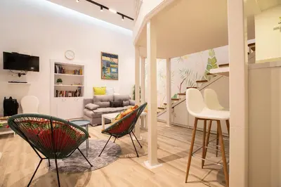 a living room with chairs and a couch at KARIOKA apartman in Belgrade