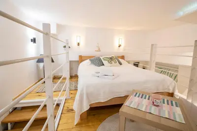 a small room with a bed and a table at KARIOKA apartman in Belgrade