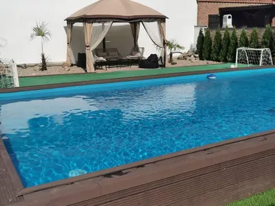 a swimming pool with a gazebo in a yard at Excellent Time in Belgrade