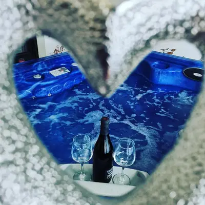 a heart shaped picture of a bottle of wine and two glasses at Excellent Time in Belgrade