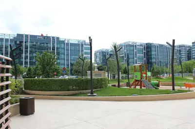 a park with a playground in front of some buildings at Wellport30 in Belgrade