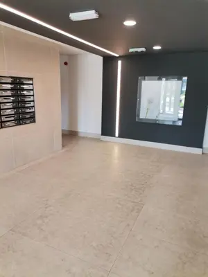 a large empty room with a tile floor and a wall at Wellport30 in Belgrade