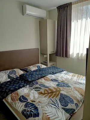 a bedroom with a bed with a quilt on it at Apartments Srbija Waterfront - FREE PARKING in Belgrade