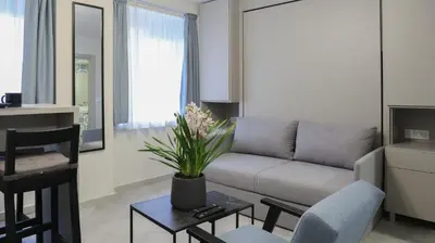 a living room with a couch and a table at Apartments Srbija Waterfront - FREE PARKING in Belgrade