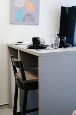 a white table with a chair and a computer monitor at Apartments Srbija Waterfront - FREE PARKING in Belgrade