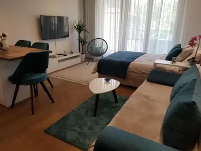 a living room with a bed and a couch at Azura Residence - new luxury apartment in Belgrade