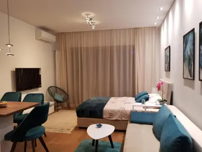 a bedroom with a bed and a couch and a table at Azura Residence - new luxury apartment in Belgrade