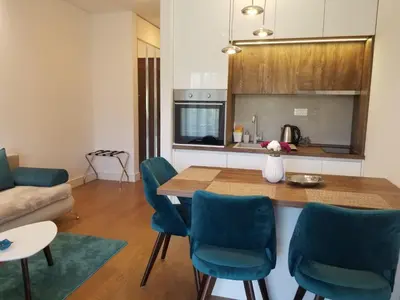 a kitchen and living room with a table and chairs at Azura Residence - new luxury apartment in Belgrade