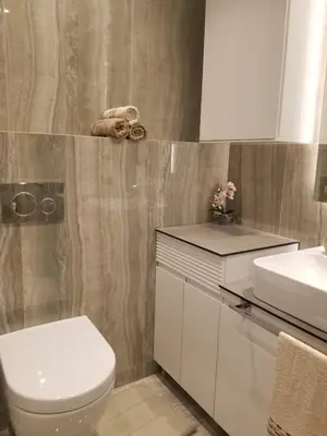 a bathroom with a white toilet and a sink at Azura Residence - new luxury apartment in Belgrade