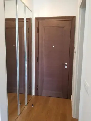 two brown doors in a room with wooden floors at Azura Residence - new luxury apartment in Belgrade