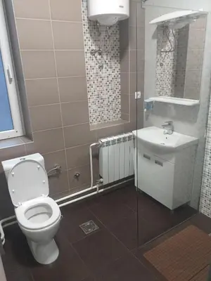 a bathroom with a toilet and a sink at BUDGET Apartment Artistika, 3 Bedrooms and 2 full Bathrooms in Belgrade