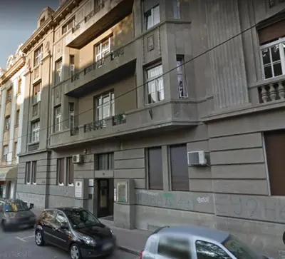 a building with cars parked in front of it at BUDGET Apartment Artistika, 3 Bedrooms and 2 full Bathrooms in Belgrade