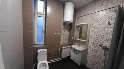 a bathroom with a toilet and a sink at BUDGET Apartment Artistika, 3 Bedrooms and 2 full Bathrooms in Belgrade