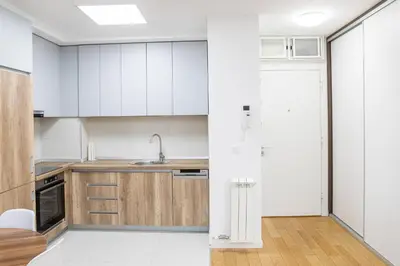 a kitchen with white cabinets and a sink at Apartment N2 - A Blok in Belgrade
