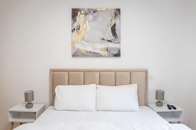 a bedroom with a bed with two night stands at Apartment N2 - A Blok in Belgrade