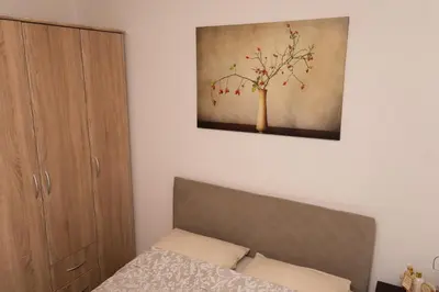 a bedroom with a bed and a painting on the wall at apartman Fuerte 2 in Belgrade