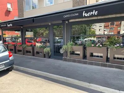 a store front with potted plants in the windows at apartman Fuerte 2 in Belgrade