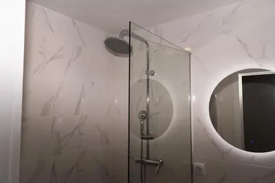 a bathroom with a shower with a mirror at apartman Fuerte 2 in Belgrade