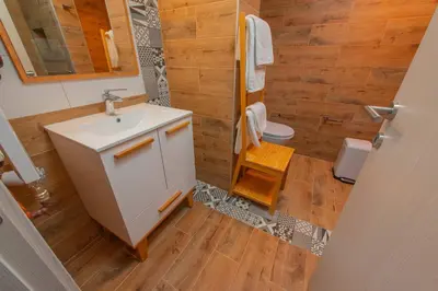 a bathroom with a sink and a shower and a toilet at Apartmani Maximilian in Čukarica