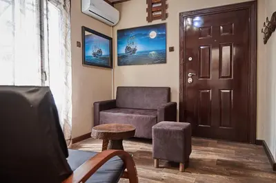 a living room with a chair and a door at BOTANIK in Belgrade