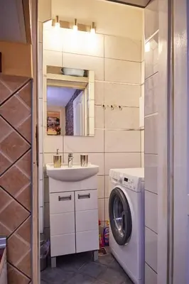 a bathroom with a sink and a washing machine at BOTANIK in Belgrade