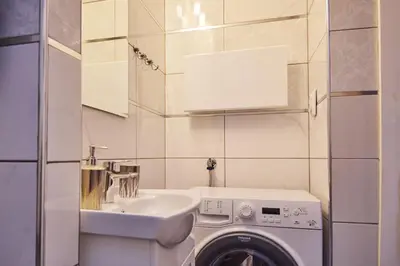 a bathroom with a washing machine and a sink at BOTANIK in Belgrade