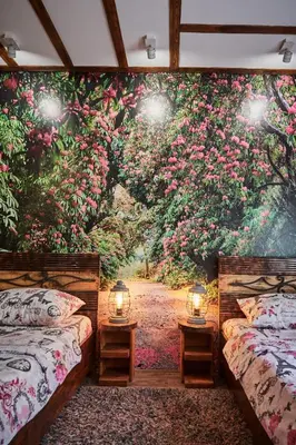 two beds in a room with flowers on the wall at BOTANIK in Belgrade