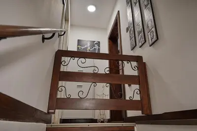 a stairway with a wooden and wrought iron railing at BOTANIK in Belgrade