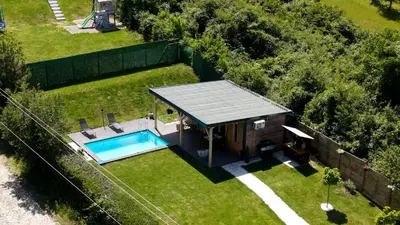 an overhead view of a tiny house with a swimming pool at Woody House in Krčedin