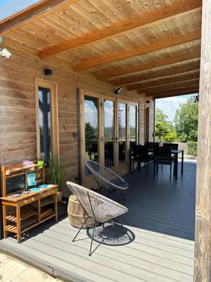a wooden deck with chairs and a table at Woody House in Krčedin