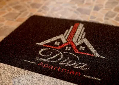 a black mat with a pair of scissors on it at Diva apartman in Arandjelovac