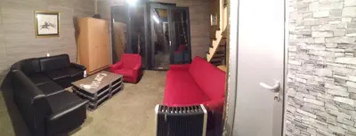 a living room with a couch and red chairs at Top Chill party kucice apartmani in Belgrade