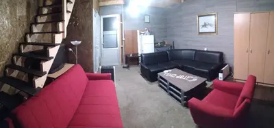 a living room with red couches and a staircase at Top Chill party kucice apartmani in Belgrade