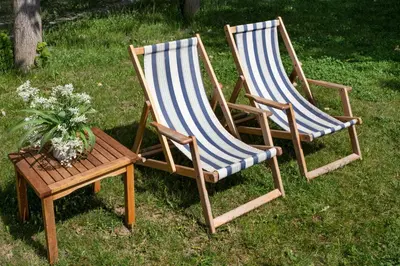 two lawn chairs and a table with a potted plant at River house Grana in Belgrade