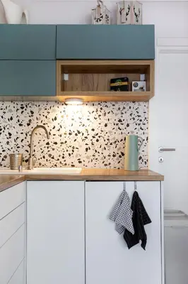 a kitchen with white cabinets and a counter top at River house Grana in Belgrade