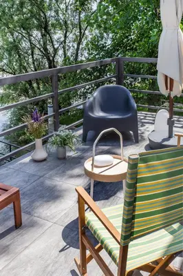 a deck with chairs and a table and a chair at River house Grana in Belgrade
