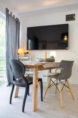 a dining room with a wooden table and two chairs at River house Grana in Belgrade