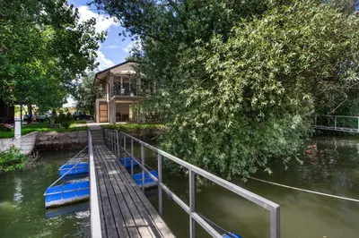 two boats are docked next to a house on a river at River house Grana in Belgrade