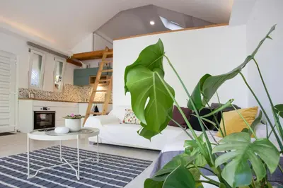 a living room with a white couch and a table at River house Grana in Belgrade
