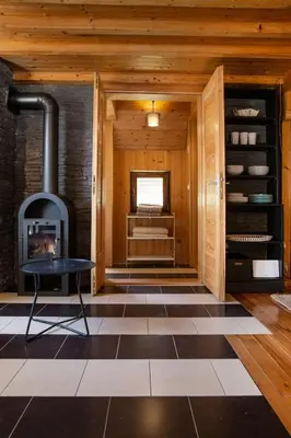a room with a fireplace and a room with a table at River house Vasa in Belgrade