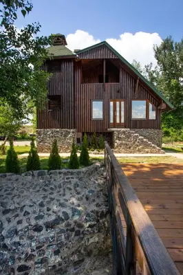 a wooden house with a stone walkway in front of it at River house Vasa in Belgrade