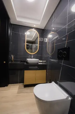 a bathroom with a toilet and a sink and a mirror at Hotel Borneo in Pančevo