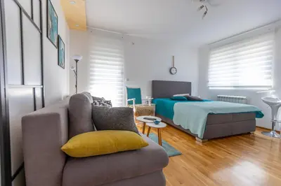 a living room with a couch and a bed at Apartment SELF CHECK IN 00-24 MM in Belgrade