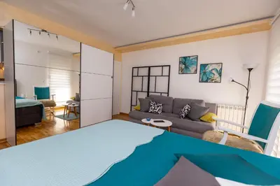 a living room with a couch and a table at Apartment SELF CHECK IN 00-24 MM in Belgrade