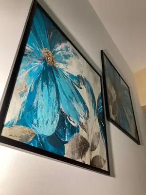 a painting of a blue flower on a wall at Apartment SELF CHECK IN 00-24 MM in Belgrade