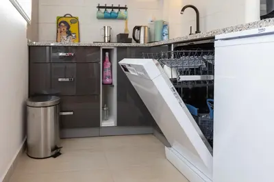 a kitchen with a sink and a dishwasher at Apartment SELF CHECK IN 00-24 MM in Belgrade