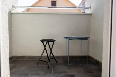 two blue tables in a room with a wall at Apartment SELF CHECK IN 00-24 MM in Belgrade