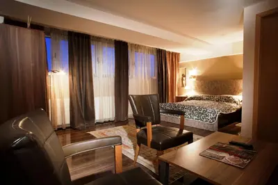 a hotel room with a bed and a living room at B&B Stadion in Belgrade